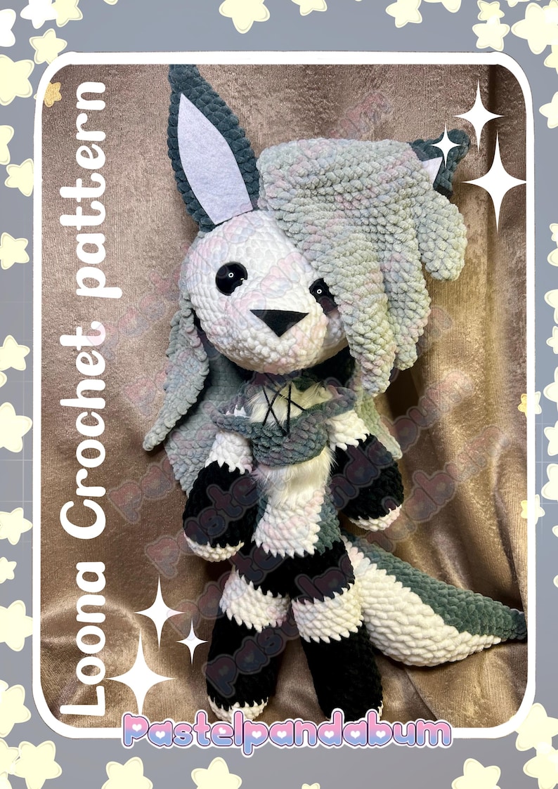 May include: A handmade crochet plushie of a bunny with a white and gray color scheme. The bunny has large ears, black eyes, and a black nose. The plushie has a scarf and striped legs. The text "Loona Crochet pattern" and "Pastelpandabum" are visible.