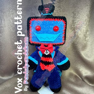 May include: A blue and red crocheted robot toy with a black antenna and a bow tie. The robot has a square head with a smiling face and red eyes.