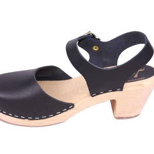 Black leather clogs. Highwood black womens clogs on a natural wooden clogs base.