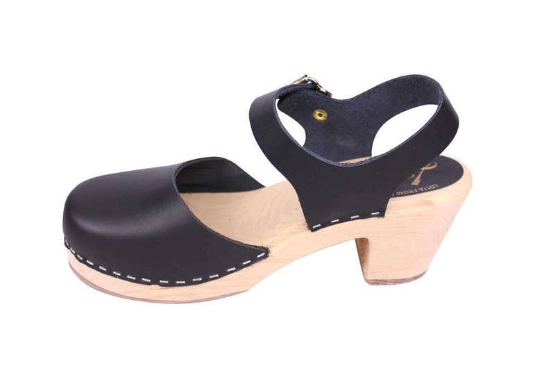 Black leather clogs. Highwood black womens clogs on a natural wooden clogs base.