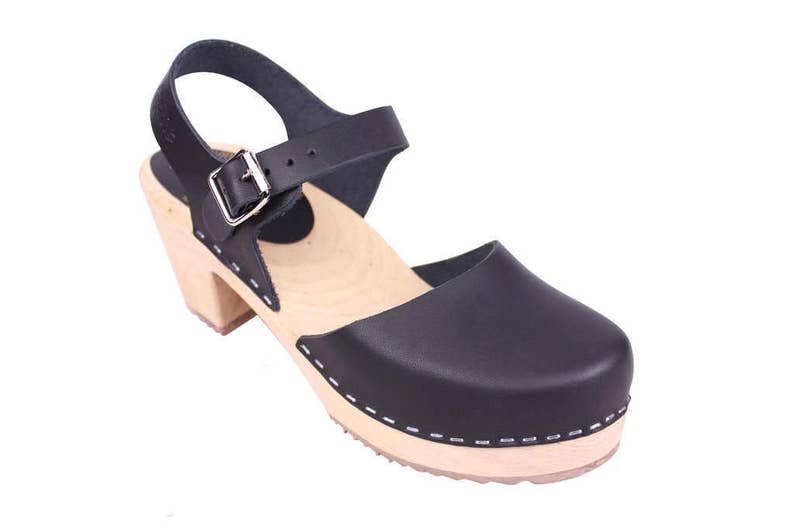 Black leather clogs. Highwood black womens clogs on a natural wooden clogs base.