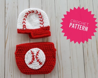 May include: A crochet baseball-themed set, including a hat and diaper cover. The hat is white with red stitching and a red brim. The diaper cover is red with a white baseball applique. The image also includes a pink starburst with the text "CROCHET PATTERN".