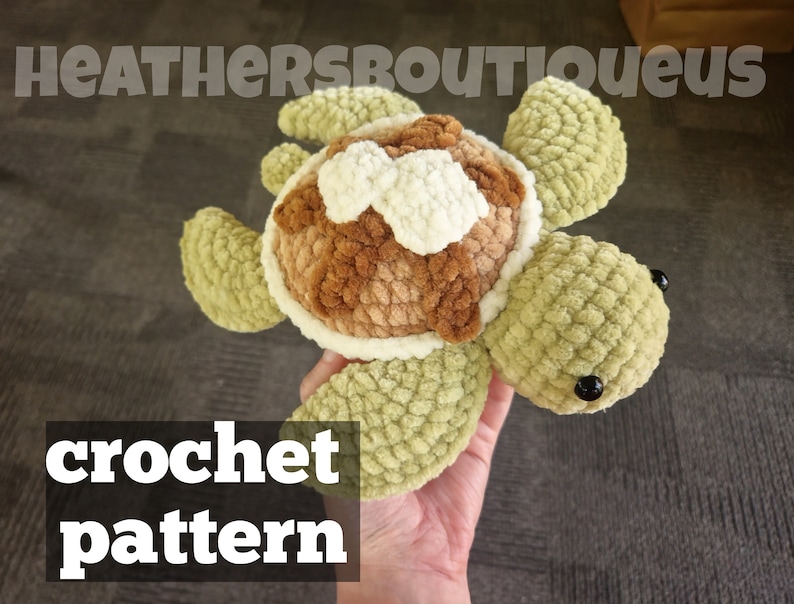 May include: A crocheted sea turtle amigurumi toy with a brown and white shell and green body. The toy has black eyes and is being held in a hand. The text "crochet pattern" is visible below the toy.