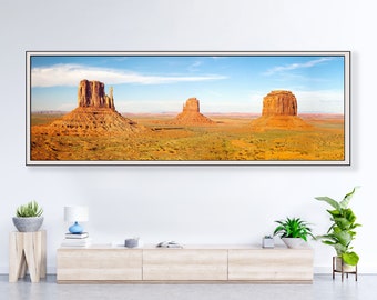 Panoramic sunset landscape of red desert buttes in Monument Valley, Utah. Art photography of stone buttes wall art for living room, bedroom.