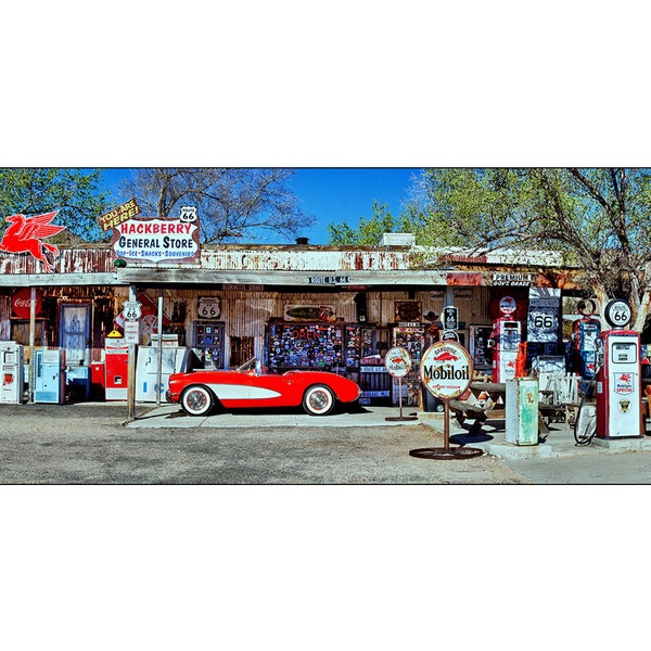 Red vintage corvette and gas station pumps and antiques on Rt66 in Hackberry, Arizona.  Size 12 x 36  inch panoramic photograph