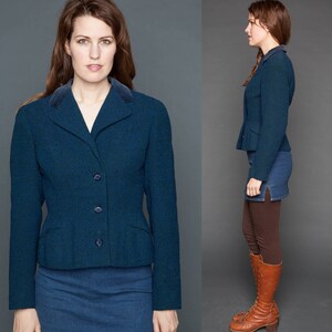 May include: A dark blue blazer with a velvet collar and a button closure. The blazer is worn over a matching skirt.