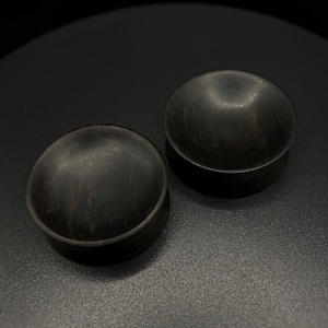 Concave black hornbeam wood plugs. Black wood gauges