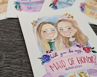 Puede incluir: Una ilustración de acuarela de dos mujeres con el texto "¿Quieres ser mi dama de honor? 10/10/2020". Las mujeres sonríen y tienen el pelo largo y castaño. La ilustración está rodeada de flores y hojas.