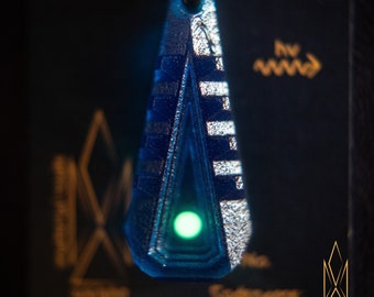 Entry Tactility, translucent geometric pendant made of dark blue resin, green glowing inlays, futuristic jewelry, cyberpunk, sci-fi, tron