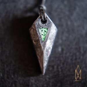 Forged Carbon fiber pendant with green glowing chunks, glow in the dark inclusions, sci-fi, futuristic, cosplay, tron, cyberpunk jewelry