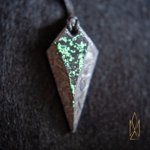 Forged Carbon fiber pendant with green glowing chunks, glow in the dark inclusions, sci-fi, futuristic, cosplay, tron, cyberpunk jewelry