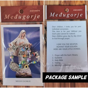 May include: A package sample for a rosary bracelet with colorful beads and a silver charm. The package includes a card with the text "I give you the weapon against your Goliath. Here are your little stones: 1. Prayer with the heart: Rosary 2. Eucharist 3. Holy Bible 4. Fasting 5. Monthly confession" and the words "Međugorje" printed on it.
