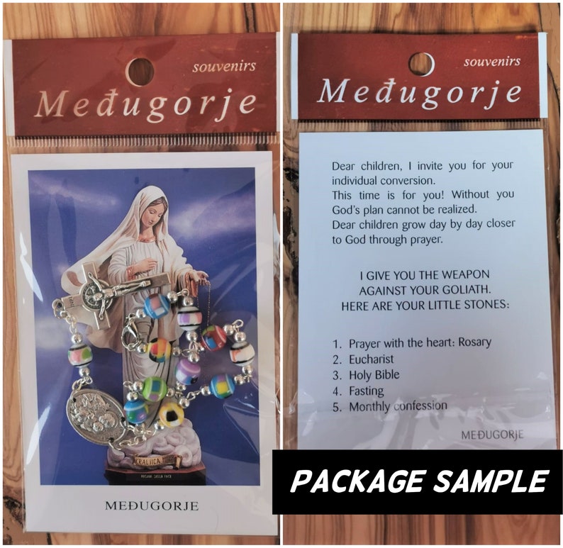 May include: A package sample for a rosary bracelet with colorful beads and a silver charm. The package includes a card with the text "I give you the weapon against your Goliath. Here are your little stones: 1. Prayer with the heart: Rosary 2. Eucharist 3. Holy Bible 4. Fasting 5. Monthly confession" and the words "Međugorje" printed on it.