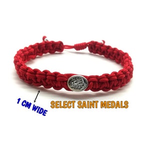 May include: Red braided bracelet with a silver oval saint medal. The bracelet is 1 cm wide and adjustable. Text on the image reads "SELECT SAINT MEDALS".