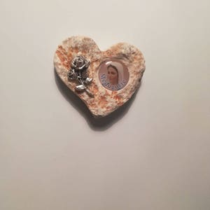 K&ouml;nnte beinhalten: Ein herzf&ouml;rmiger Stein mit einem Bild der Jungfrau Maria und dem Wort "Medjugorje" darin. Eine silberne Rose ist an der Seite des Herzens befestigt.