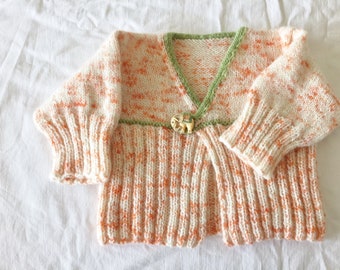 Speckled orange and green baby sweater with elephant button