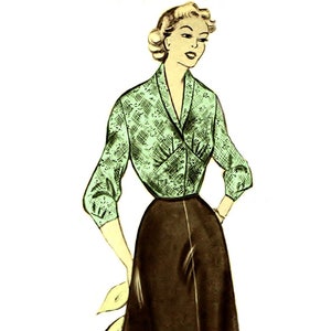May include: A woman wearing a green and white patterned blouse with a brown skirt. The blouse has a collar and long sleeves. The skirt is a-line and falls to just below the knee.