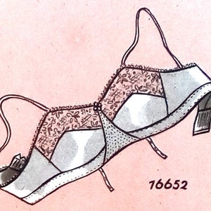 May include: A black and white illustration of a bra with a lace design. The bra has a number 76652 printed on the bottom right corner.