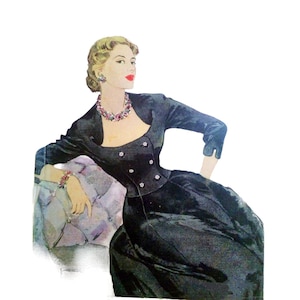 May include: A woman in a black velvet dress and jacket with a jeweled neckline sits on a chair with a purple cushion. She is wearing a jeweled bracelet on her left wrist.