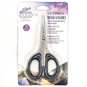 May include: Silver scrapbooking micro-scissors with black handles. The packaging features the text "Scrapbooking Micro-Scissors" and "Ideal For Cutting Small Items Or Intricate Designs".