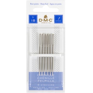 May include: A package of DMC chenille needles, size 18, with sharp ends. The package is white and blue, with the DMC logo and text in multiple languages. The package contains 6 needles.