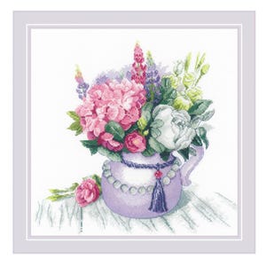 May include: Cross-stitch artwork of a floral arrangement in a lavender pitcher. The bouquet features pink hydrangeas, white roses, and purple lupines. A single pink rose rests near the pitcher. The pitcher is adorned with a pearl necklace and a tassel.