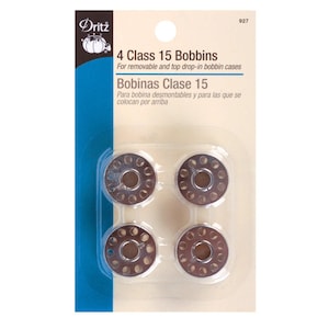 May include: Package of four Class 15 bobbins for sewing machines. The bobbins are silver-colored metal with multiple holes around the perimeter. The packaging includes the text "Dritz" and "4 Class 15 Bobbins".