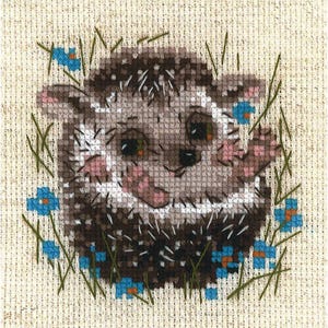 May include: A cross-stitch pattern of a brown and white hedgehog with a pink nose and green eyes. The hedgehog is surrounded by blue flowers and green leaves.