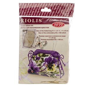 May include: A cross stitch kit by RIOLIS, featuring a completed floral design on a purple drawstring bag. The kit includes the bag, embroidery materials, and instructions. The folded bag measures 4 1/4" x 3 1/4" (11 x 8 cm).