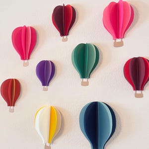 3D paper hot air balloons in custom colors.