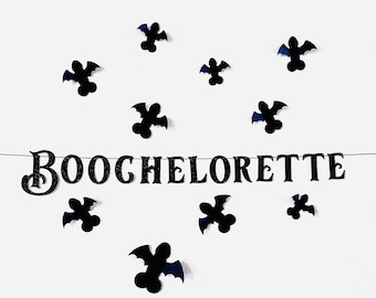 May include: Black and white banner with the text "BOOchelorette" and black bat cutouts on a white background.