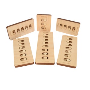May include: Six wooden puzzle boards with the word "ACTION" printed on each. Each board has eight slots with a round wooden peg in each slot.