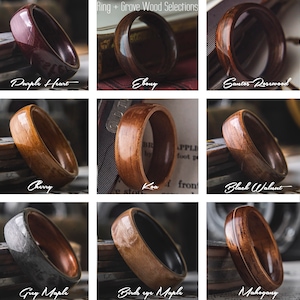 Op de afbeelding: Negen verschillende houten ringen met een zwarte ringinleg. De houtsoorten zijn Purple Heart, Ebony, Santos Rosewood, Cherry, Koa, Black Walnut, Grey Maple, Birds Eye Maple en Mahogany.