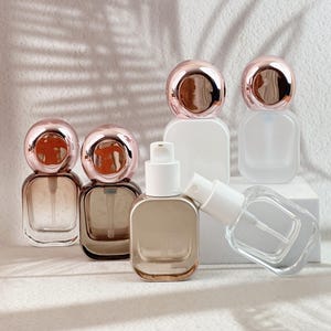 All six 20ml perfume bottle finishes displayed together, with rose gold caps and white spray pumps.