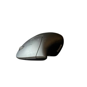 May include: A gray and black ergonomic computer mouse with the brand name "ANKER" visible on the side. The mouse has a curved design and a scroll wheel.