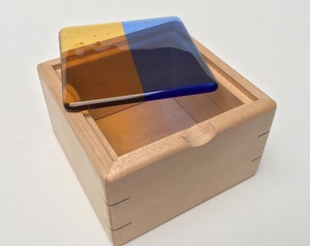 Maple jewellery box with blue and amber kiln formed glass lid