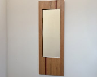 Oak wall mirror with rust red glass insert