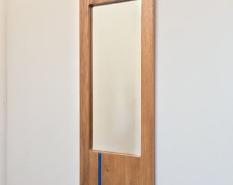 Oak wall mirror with bright blue glass insert