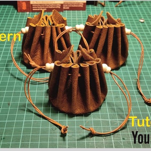 May include: Three brown leather pouches with drawstrings and white beads. The pouches are on a green cutting mat. The text "Pattern" and "Tutorial" are visible in the image. The text "YouTube" is visible in a red box.