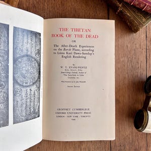 May include: The cover of a book titled "The Tibetan Book of the Dead" by W.Y. Evans-Wentz. The book was published by Oxford University Press in 1949.