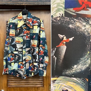 May include: A black button-down shirt with a colorful print of various Disney characters, including Mickey Mouse, Donald Duck, and Goofy. The shirt features a variety of scenes from classic Disney films.