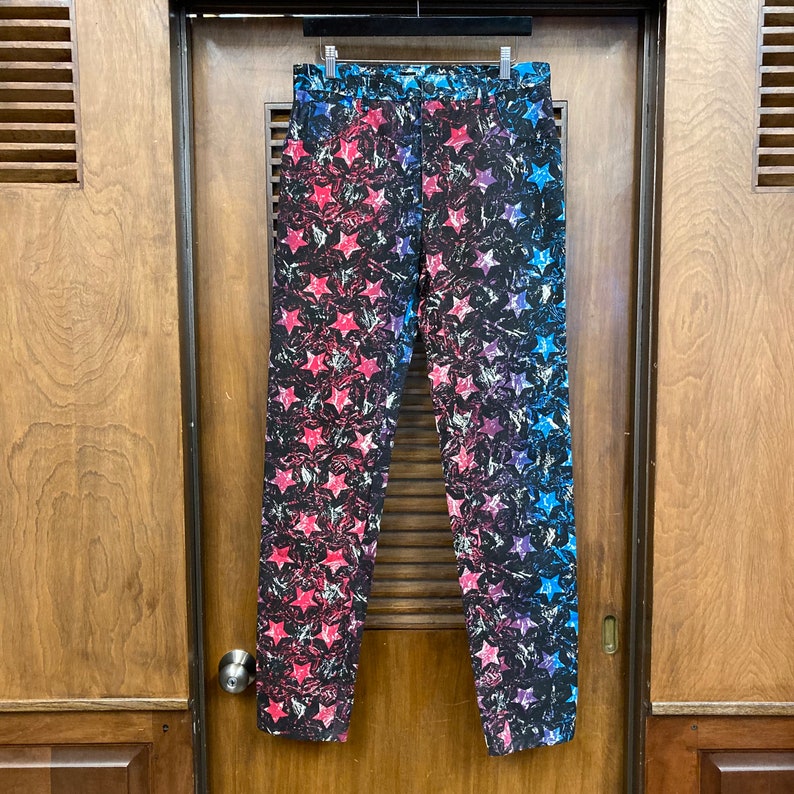 May include: A pair of black pants with a blue, red, and white star pattern.