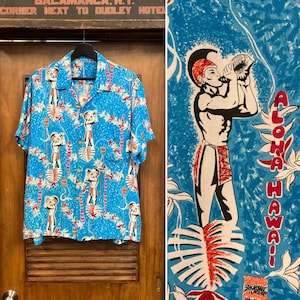 1960年代のヴィンテージ アトミックティキ カートゥーン レーヨン ループカラー 半袖 ハワイアンシャツ、同系色のポケット、1950年代シャツ