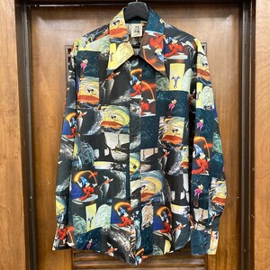 May include: A black long-sleeved button-up shirt with a colorful all-over print of Mickey Mouse as the Sorcerer's Apprentice from Fantasia. The print features Mickey Mouse in various poses, including casting spells and riding a broomstick.
