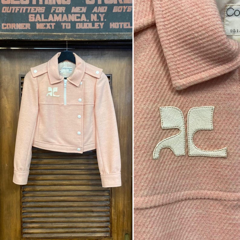 May include: A pink cropped jacket with a white zipper and white buttons. The jacket has a white "AC" logo on the front.