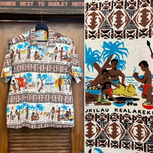 May include: Short-sleeved button-down shirt with a tropical print. The shirt features a cream background with illustrations of people, boats, and palm trees in shades of brown, blue, and red. The shirt is hanging on a wooden door.