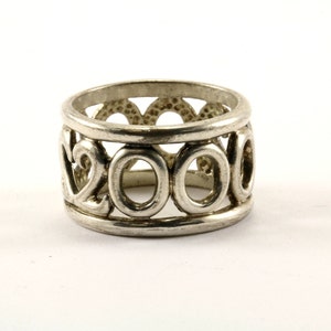 May include: Silver ring with the year 2000 etched into the band.
