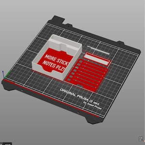 May include: A 3D-printed organizer set, including a white rectangular box with the text "MORE STICK NOTES PLZ!" on a red background, and several red and white components. The set is on a black grid surface, with "ORIGINAL PRUSA i3 MK3" text.