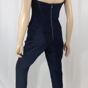 May include: A navy blue strapless jumpsuit with a zipper down the back.