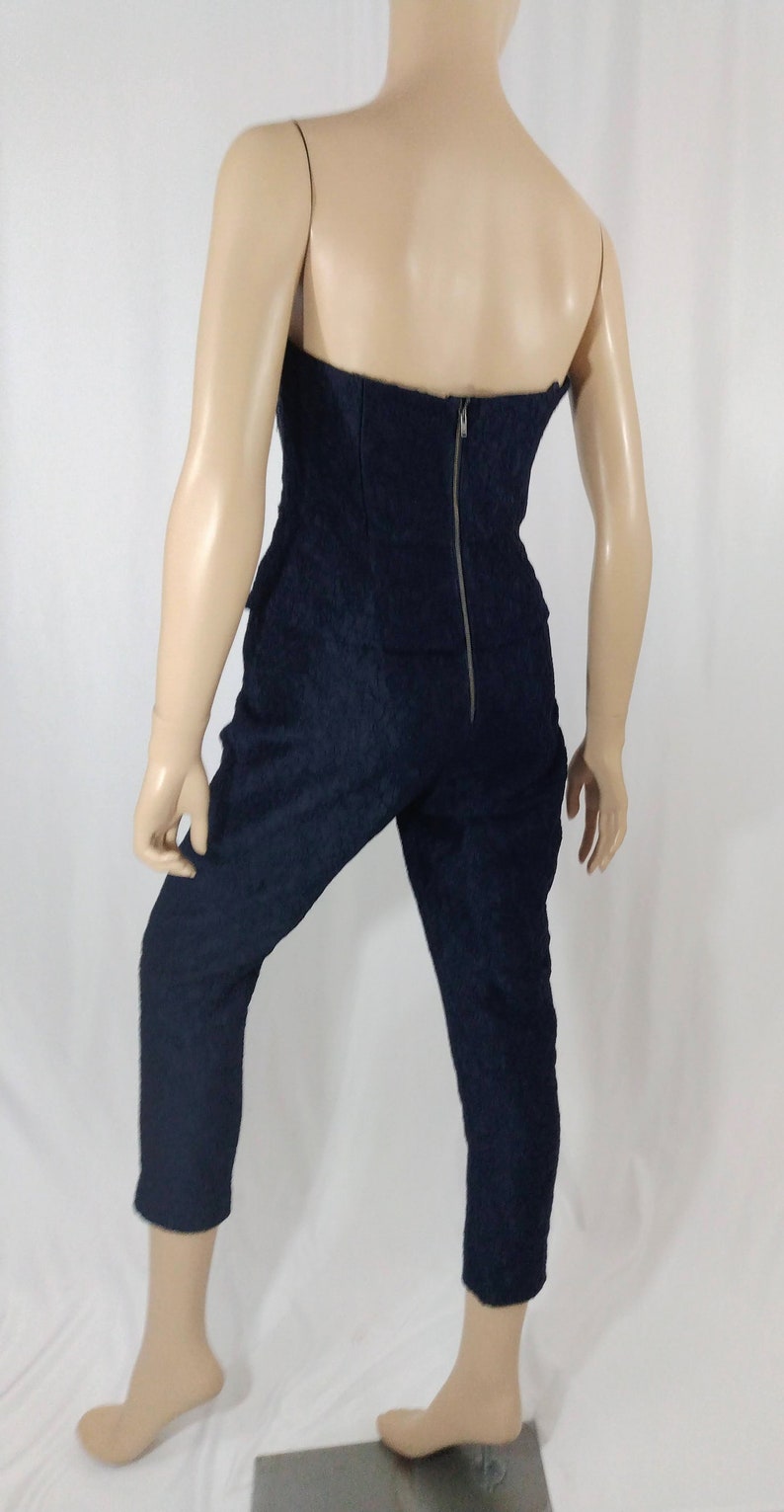 May include: A navy blue strapless jumpsuit with a zipper down the back.